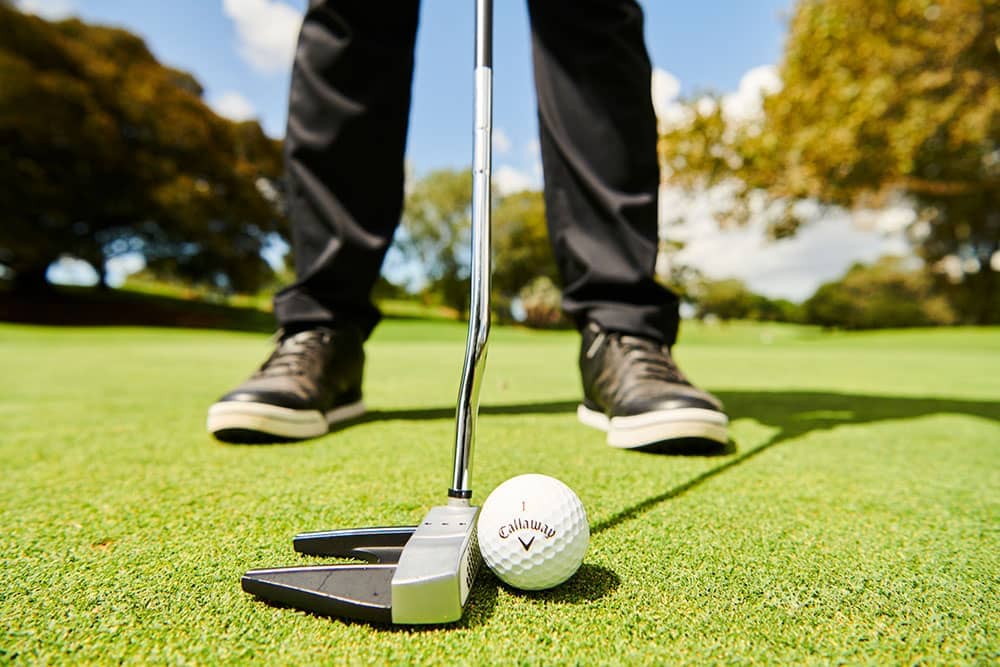 a golfer with a mallet putter