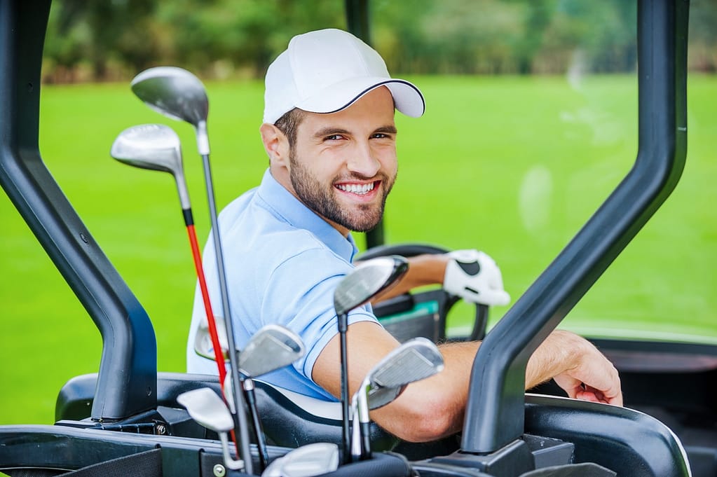 golfer in golf cart 2022 12 16 14 09 35 utc scaled