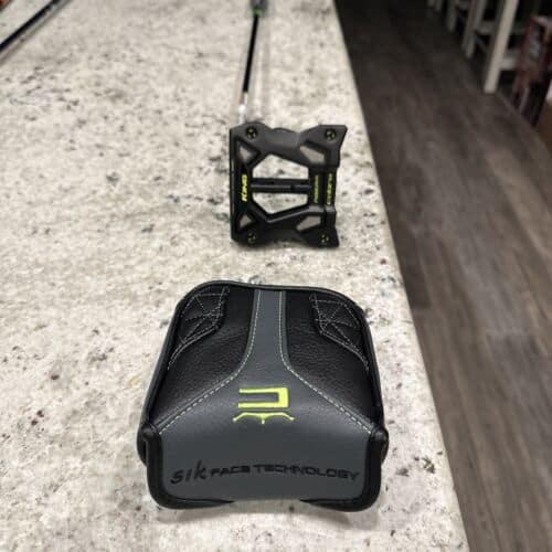 A Cobra King 3D Printed Agera Putter with cover in a table